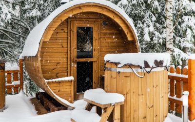 barrel-shaped outdoor sauna covered in snow